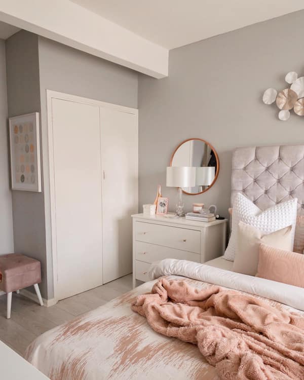 Round Mirror Behind the Lamp on the Bedside Dresser