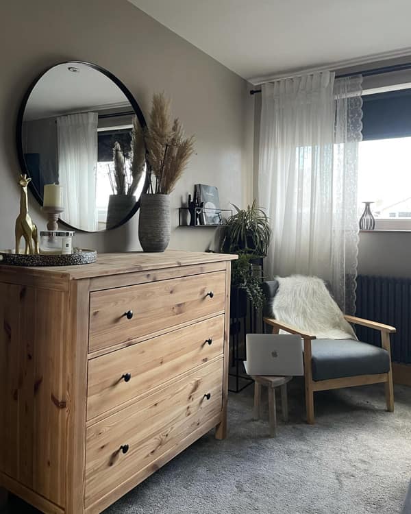 Round Mirror over the Dresser Opposite the Bed